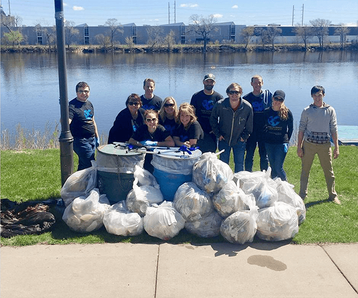 DC Group employees and earth day bounty of trash bags